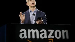 Amazon CEO Jeff Bezos demonstrates the new Amazon Fire Phone, Wednesday, June 18, 2014, in Seattle. (AP Photo/Ted S. Warren)