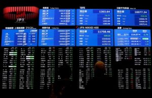 Visitors looks at an electronic board showing the Japan's Nikkei average (top R) at the Tokyo Stock Exchange (TSE) in Tokyo, Japan, February 9, 2016. REUTERS/Issei Kato