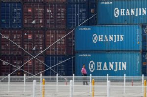 A man stands in front of shipping containers at the Hanjin Shipping container terminal at Incheon New Port in Incheon, South Korea, September 7, 2016. REUTERS/Kim Hong-Ji