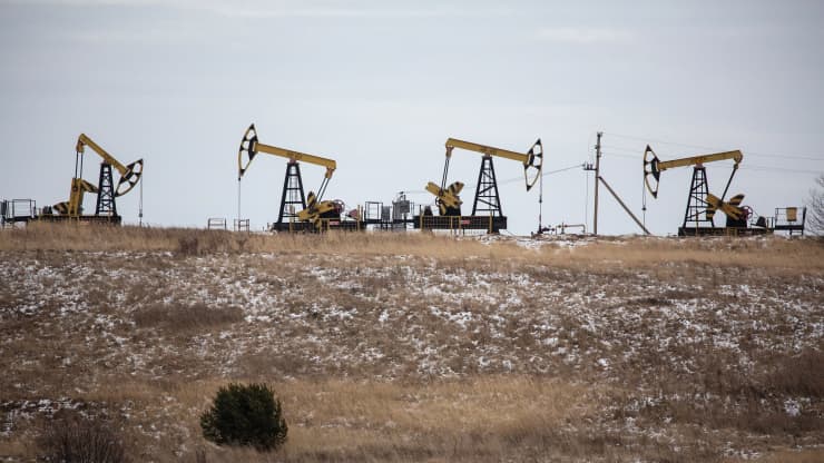 Oil rises on falling U.S. crude stocks, demand hope on stimulus
